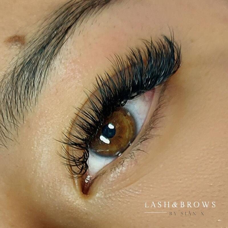 Volume lash extensions on a brown eye, close up
