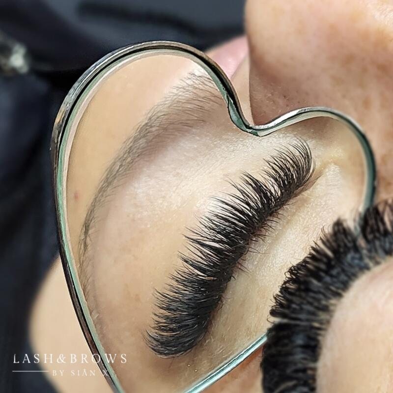 Lashes reflected in a heart-shaped mirror